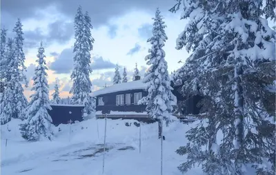 a cabin in the snow with snow covered trees at Gorgeous Home In Lillehammer With Wifi in Lillehammer