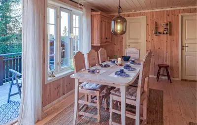 a dining room with a table on a porch at Gorgeous Home In Lillehammer With Wifi in Lillehammer