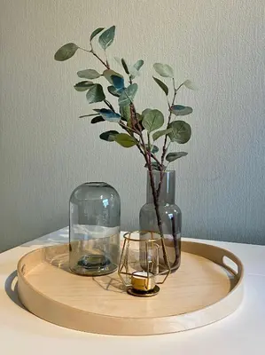 a wooden tray with two glass vases and a plant at Apartment «Ladegården» in Bergen in Bergen