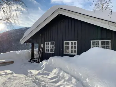 a house with a pile of snow in front of it at Kultan in Åmotsdal