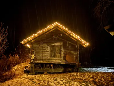 a small cabin with lights on the side of it at Kultan in Åmotsdal