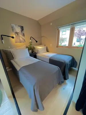 a bedroom with two beds and a window at Floien City House -free parking in Bergen