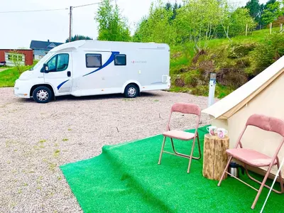 a white van parked in a parking lot with two chairs at Drømmebrygga in Averoy
