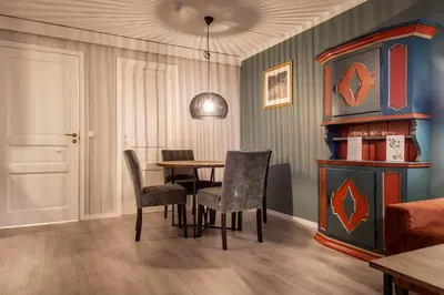 a dining room with a table and chairs at Bergo Leiligheter in Beitostøl