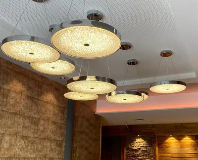 a group of lights hanging from a ceiling at Gjestegaarden Leiligheter in Beitostøl