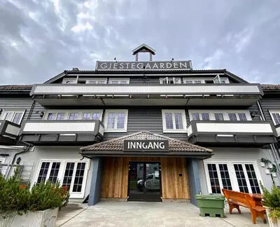 a building with a sign on the front of it at Gjestegaarden Leiligheter in Beitostøl