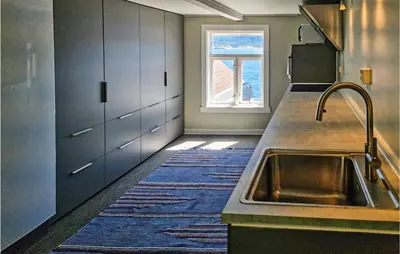 a kitchen with a sink and a window at Cozy Home In Kristiansund With Wifi in Kristiansund