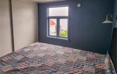 a bedroom with a bed and a window at Cozy Home In Kristiansund With Wifi in Kristiansund