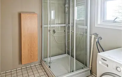 a shower with a glass door in a bathroom at Cozy Home In Kristiansund With Wifi in Kristiansund