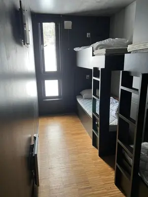 a room with two bunk beds and a window at Fin leilighet ca 30 min med bil til Hunderfossen in Favang