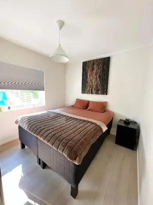 a bedroom with a large bed in a room at Ibsens in Bergen