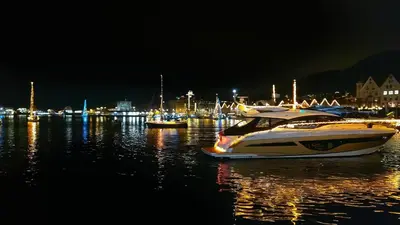 a boat sitting in the water at night at Ibsens in Bergen