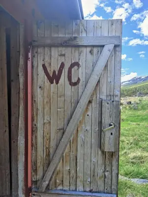a wooden door with the wordwk written on it at Kyrkjestølen B&B in Tyinkrysset