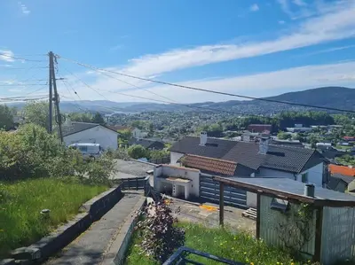 a view of a city from a hill with houses at Beautiful Villa with amazing view in Bergen. in Bergen