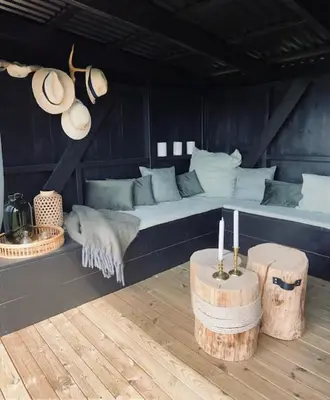 a bed in a room with two logs and two candles at Glomstad Gjestehus in Tretten