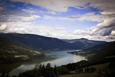 a view of a river in a valley with mountains at Glomstad Gjestehus in Tretten
