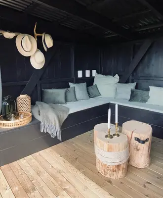 a bed in a room with two logs and two candles at Glomstad Gjestehus in Tretten
