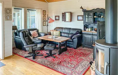 a living room with leather furniture and a table at Gorgeous Home In Øydegard in Nastad