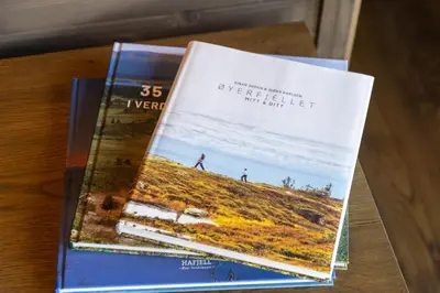 two books sitting on top of a table at Mosetertoppen Skiline - Hafjell Ski Resort in Øyer