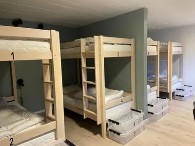 a room with four bunk beds in a room at Winjum Hostel Stegastein in Aurland