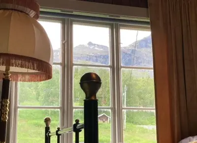 a large window with a view of a mountain at Steinsvoll Gård in Vang I Valdres