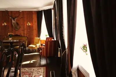 a living room with a table and a window at Sylte Hotell, Valldal in Valldal