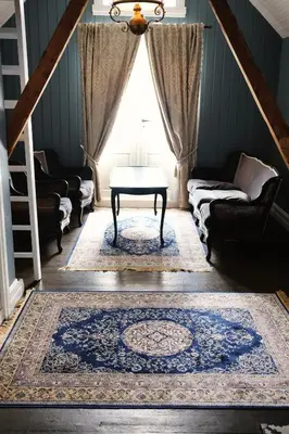a living room with a table and a window at Sylte Hotell, Valldal in Valldal