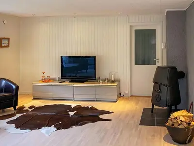 a living room with a flat screen tv and a table at 8 person holiday home in Halsanaustan-By Traum in Korsnes