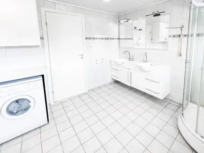 a white bathroom with a sink and a washing machine at 8 person holiday home in Halsanaustan-By Traum in Korsnes