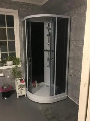 a shower with a glass enclosure in a bathroom at Dr Haave- middle of nowhere, pikeværelset in Sand