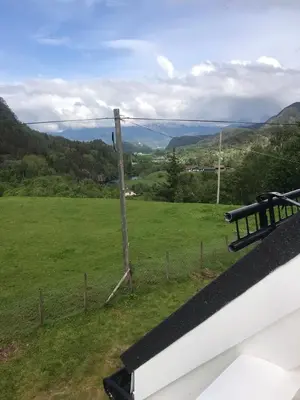 a view of a field from the balcony of a house at Dr Haave- middle of nowhere, pikeværelset in Sand