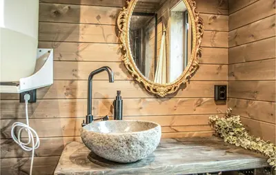 a bathroom with a stone sink and a mirror at Awesome Home In Rena With Wifi in Rena