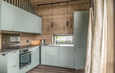 a kitchen with white cabinets and a window at Awesome Home In Rena With Wifi in Rena