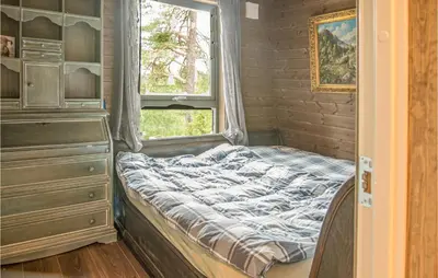 a small bedroom with a bed and a window at Awesome Home In Rena With Wifi in Rena
