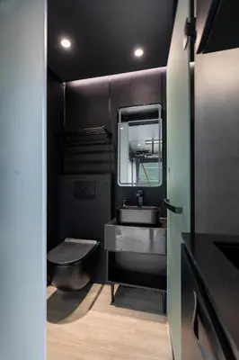 a black bathroom with a sink and a toilet at Sogndal Fjordpanorama - Studio Cabins With View in Sogndal