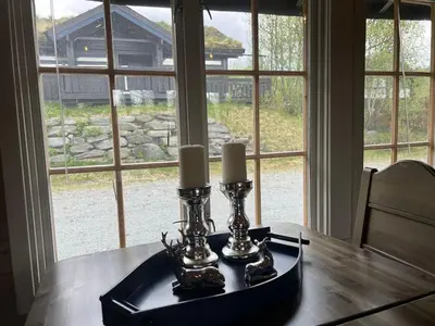 a table with candles on top of it with a window at Beitostølen sentralro in Beitostøl