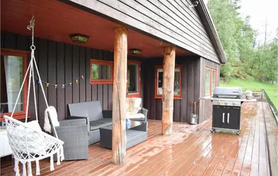 a porch of a house with a grill and a stove at 3 Bedroom Stunning Home In Vossestrand in Vossestrand