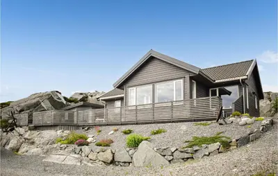 a house on top of a hill with rocks at Nice Home In Sveio With House Sea View in Sveio