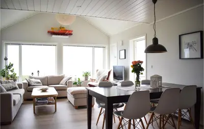 a living room with a table and chairs at Nice Home In Sveio With House Sea View in Sveio