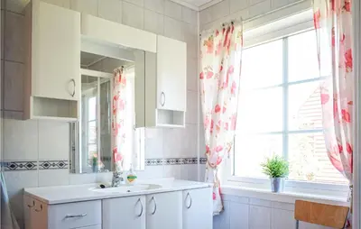 a bathroom with a sink and a window at Awesome Home In Fitjar With Wifi in Fitjar