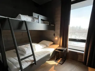 a bunk bed in a room with a window at Riddertunets moderne in Beitostøl