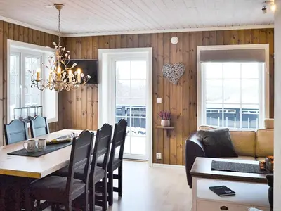 a dining room with a table and a couch and a dining room at 5 person holiday home in Rauland-By Traum in Rauland