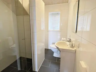 a white bathroom with a toilet and a sink at 5 person holiday home in Rauland-By Traum in Rauland
