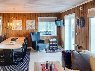 a living room with a couch and a table and chairs at 5 person holiday home in Rauland-By Traum in Rauland