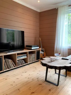 a living room with a tv and a coffee table at Nesje Gardstun in Oppstryn