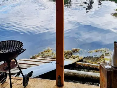 a boat sitting on a dock next to the water at 6 person holiday home in Halsanaustan-By Traum in Korsnes