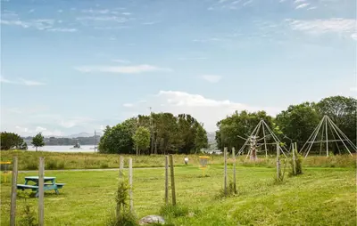 a park with a picnic table and a playground at 4 Bedroom Gorgeous Home In Herdla in Herlø