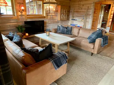 a living room with a couch and a table at Timber Lodge in Uvdal Skisenter VIEW/WIFI in Sønstebø