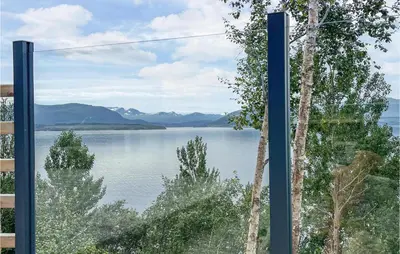 a view of a lake from a window at 4 Bedroom Nice Home In Stangvik in Stangvik