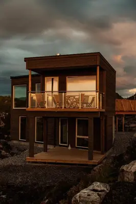 a house with a deck with a balcony at Runde Panorama - Ørneredet in Runde
